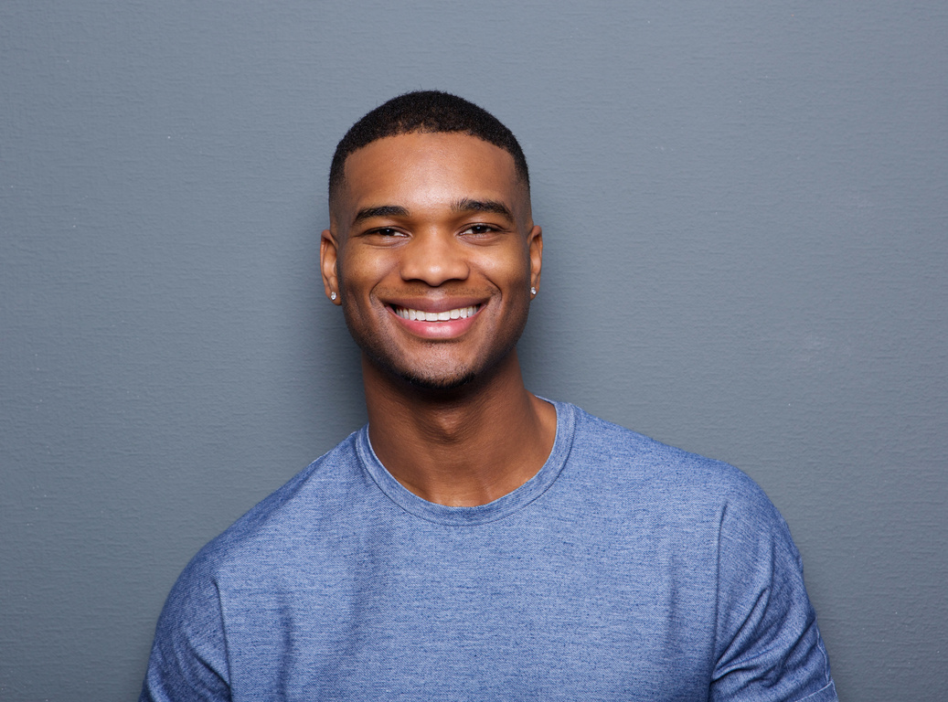 Portrait of a Smiling Man on Grey Background